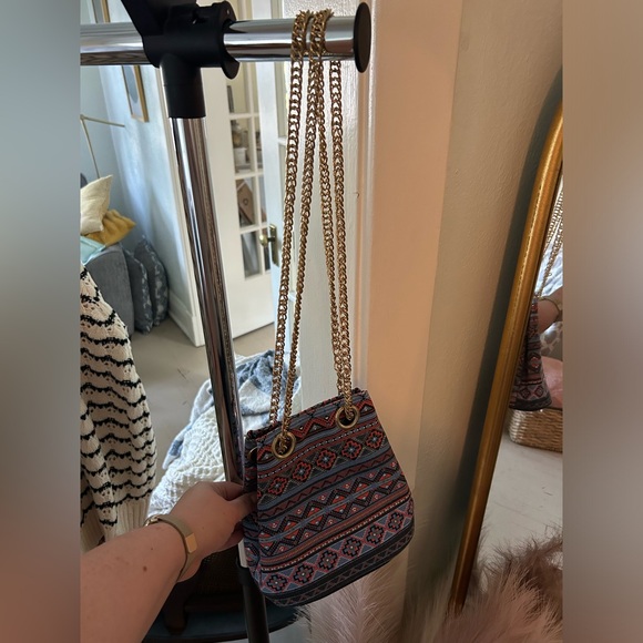Multi pattern cinch purse. Never used, new with tags. Gold chain strap. - Picture 3 of 3
